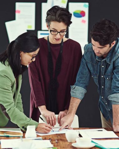 cropped shot of a group of young creatives having a meeting